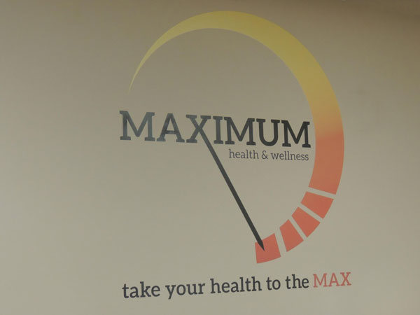Maximum Health and Wellness logo on wall